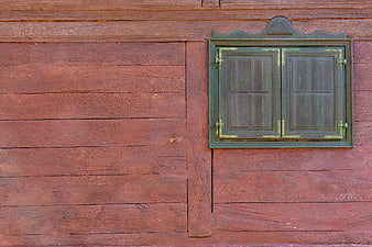 Rustic Green Wooden Window on Weathered Red Barn Wall