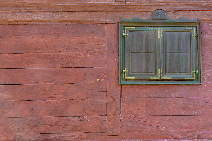 Rustic Green Wooden Window on Weathered Red Barn Wall
