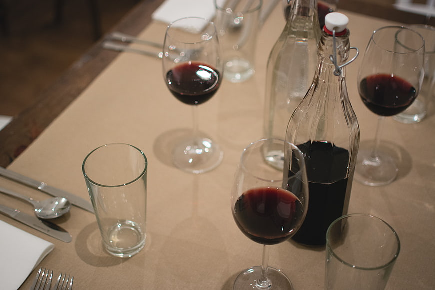 Red wine glasses and bottle on a dining table