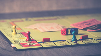 Close-up of Monopoly board game with dice and pawns