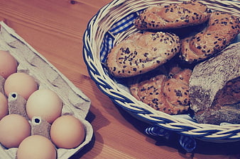 Fresh eggs and artisanal bread rolls in a basket
