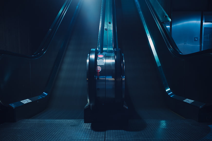Cinematic Blue Escalator in Empty Underground Station