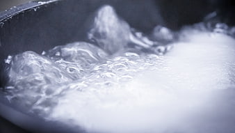 Close-up of boiling water with bubbles in a pot