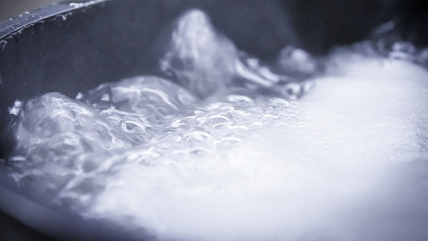 Close-up of boiling water with bubbles in a pot
