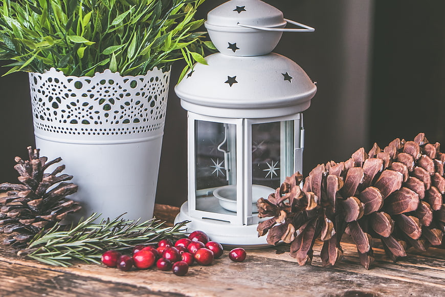 Rustic Christmas Decor with White Lantern, Pine Cones, and Cranberries
