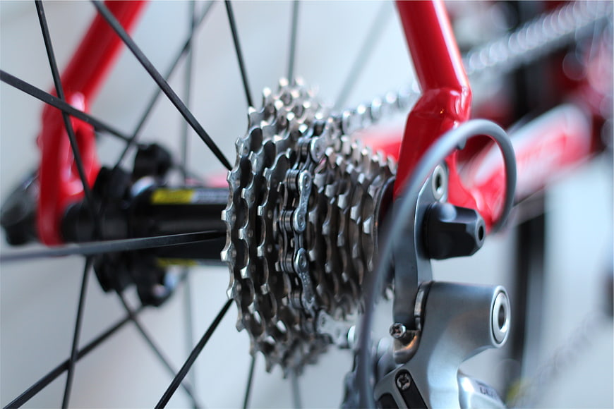 Close-up of red bicycle rear cassette and derailleur