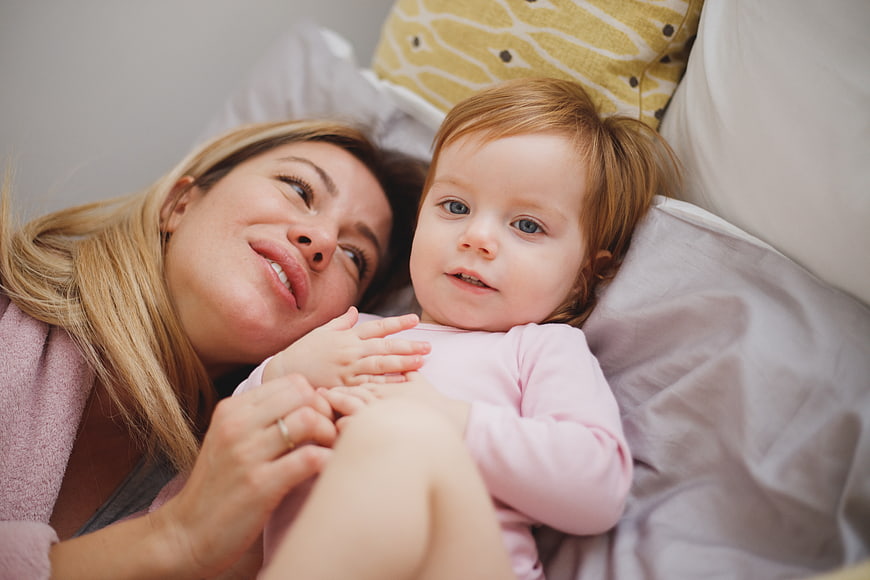 Mother and Toddughter Lying in Bed Together