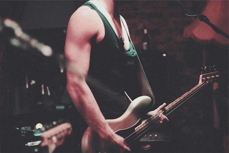 Rock Musician Playing Electric Bass Guitar on Stage
