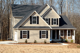 New suburban house exterior with beige siding and brick porch