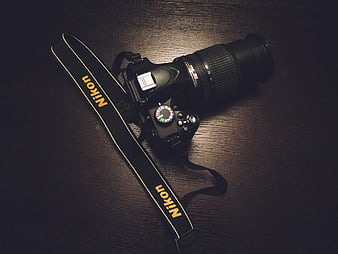 Nikon DSLR Camera on Dark Wood Table