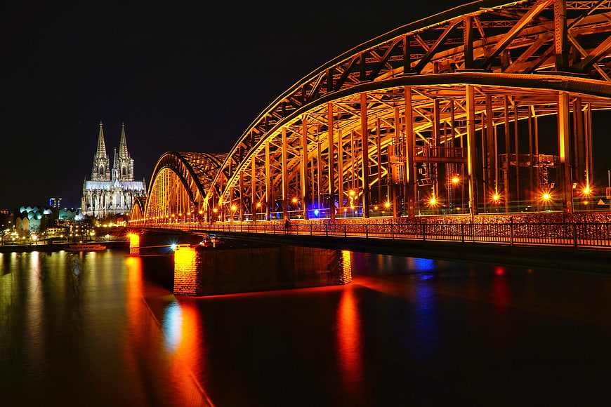 Hohenzollern Bridge and Cologne Cathedral illuminated at night