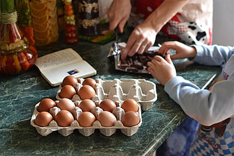 Family baking Easter eggs with chocolate and ingredients