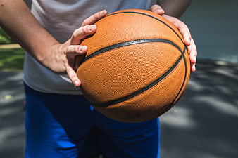 Close-up of Hands Holding a Basketball Outdoors