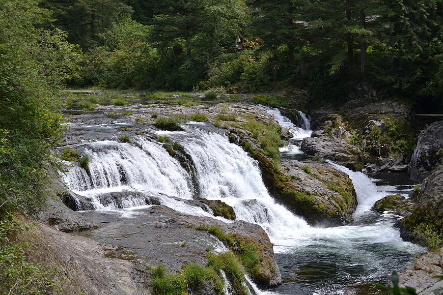 Scenic cascading waterfall flowing over mossy rocks in a forest