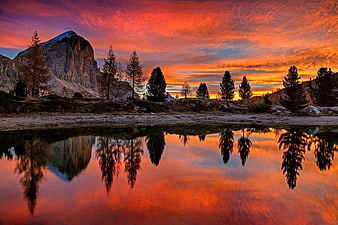 Vibrant Sunrise Reflection Over Dolomites Mountain Lake