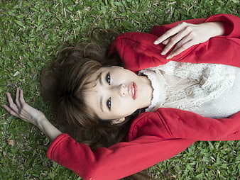 Woman in Red Blazer Lying on Green Grass