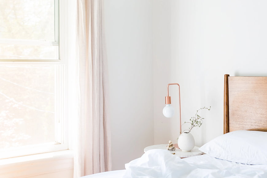 Minimalist Bedroom Interior with White Bed and Copper Lamp