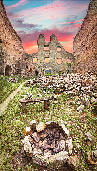 Ruined Stone Castle Interior with Dramatic Sunset Sky
