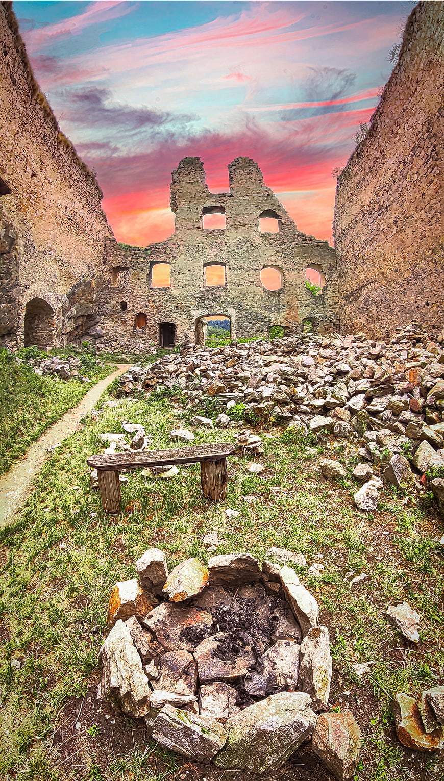 Ruined Stone Castle Interior with Dramatic Sunset Sky