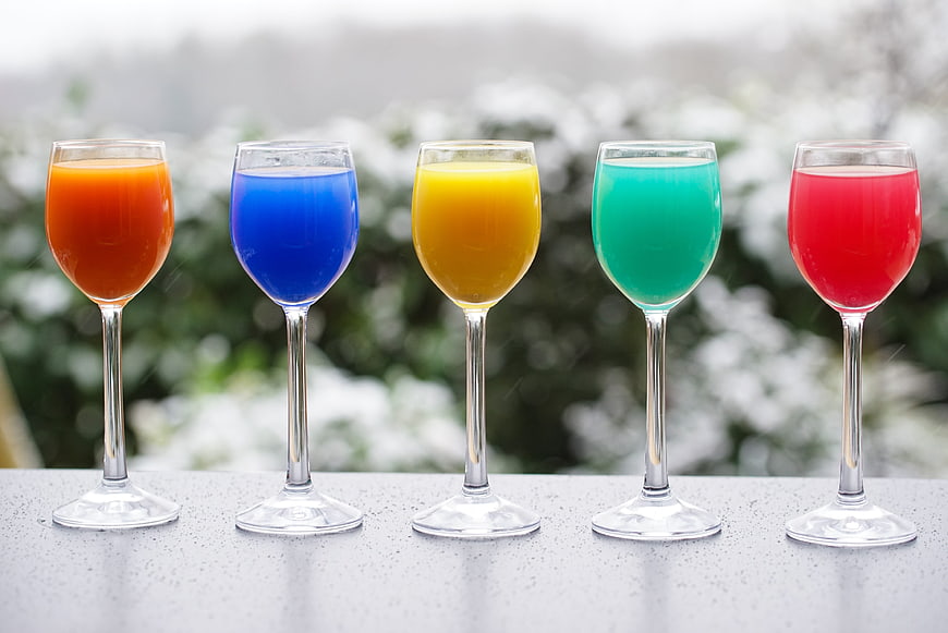 Five Colorful Cocktails in Glasses on Outdoor Table
