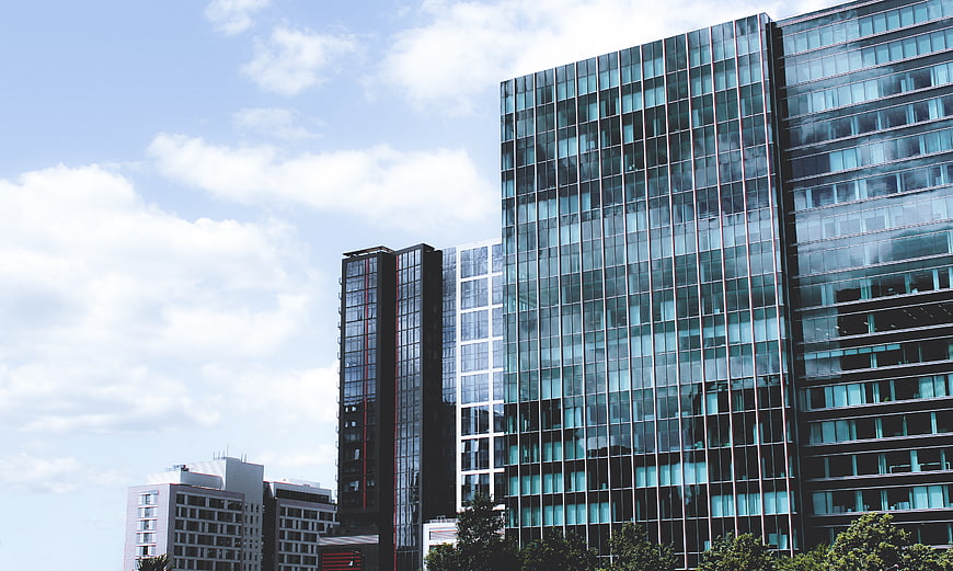 Modern Glass Office Buildings Against Blue Sky