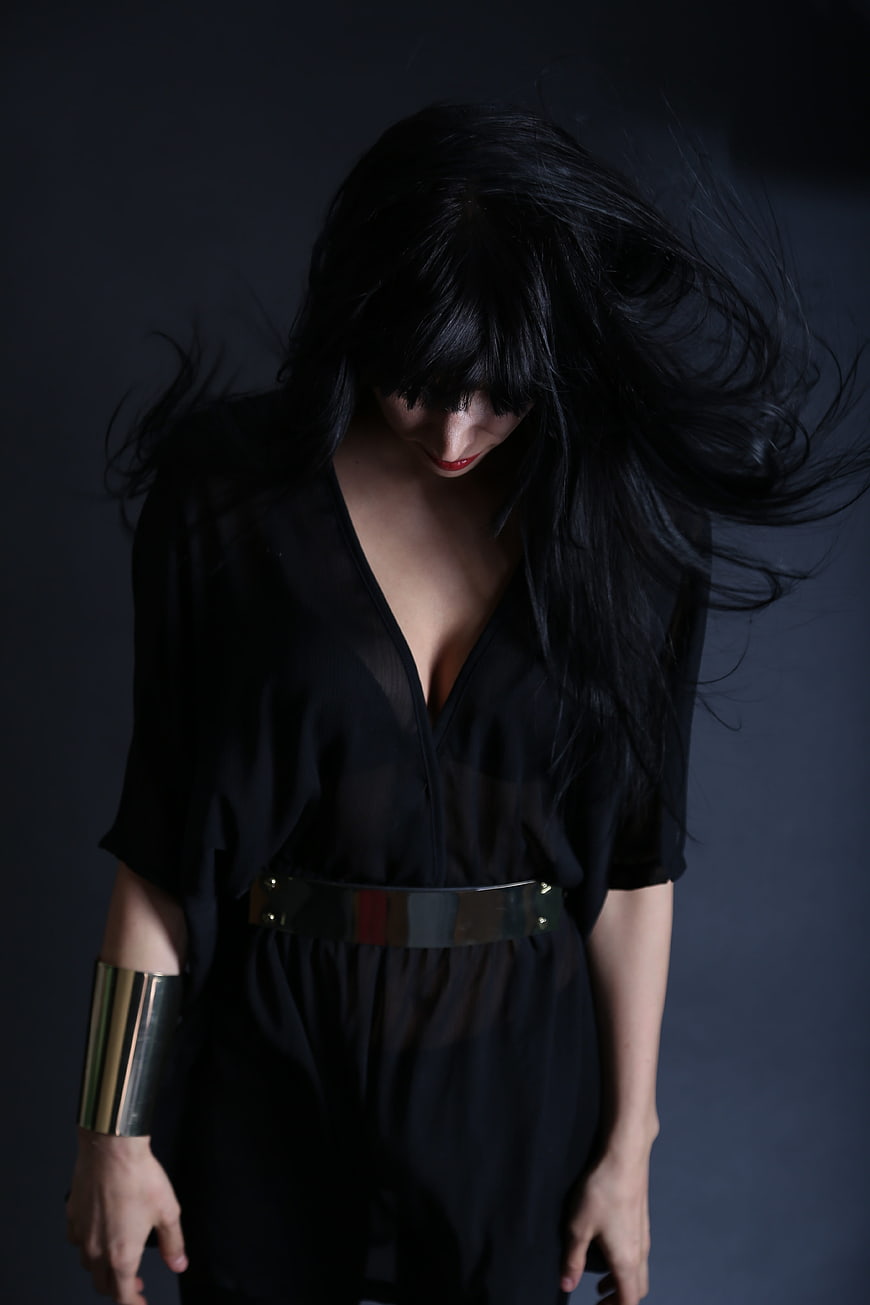 Fashion Portrait of Woman in Black with Metallic Accessories
