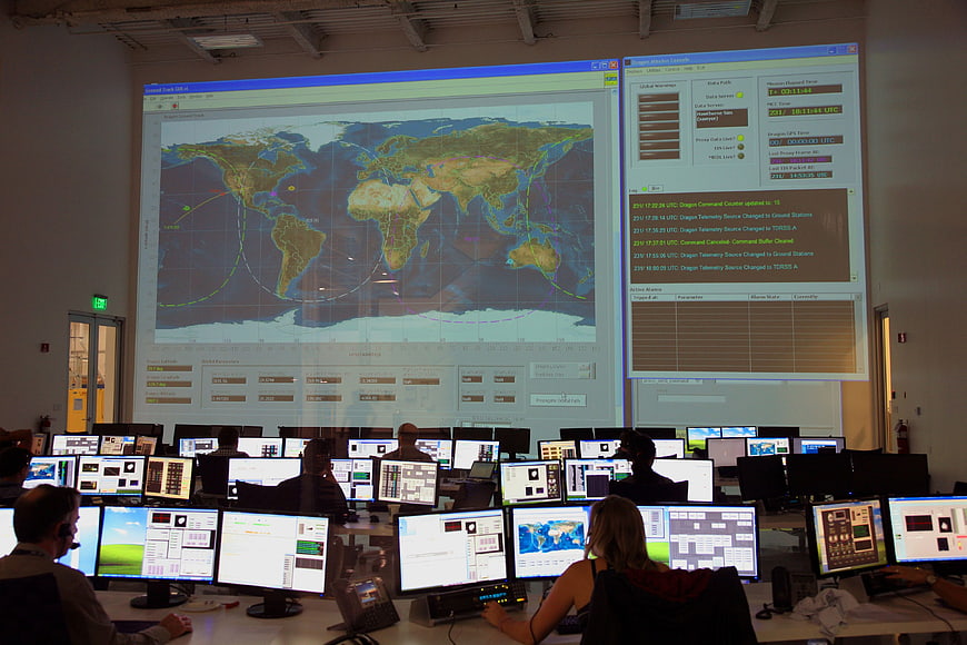 Mission control center with large world map projection and operators