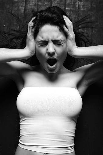 Black and white portrait of a woman screaming in anger