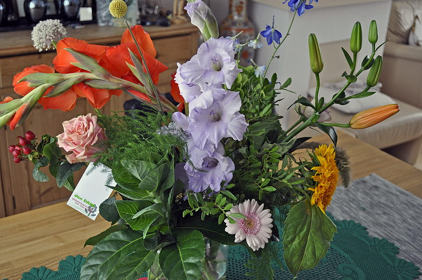 Colorful mixed flower bouquet on wooden table