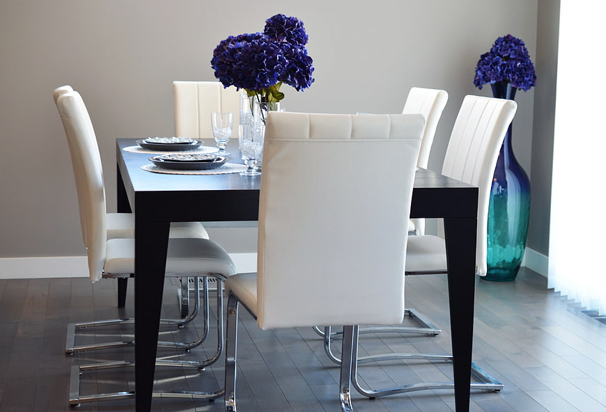Modern Dining Room with White Chairs and Purple Flowers