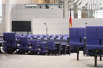 Empty Plenary Hall Interior With Blue Chairs And German Flag