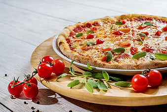 Fresh Margherita Pizza with Tomatoes and Sage on Wooden Board
