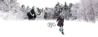 Child pulling sled in snowy forest with mammoth statue