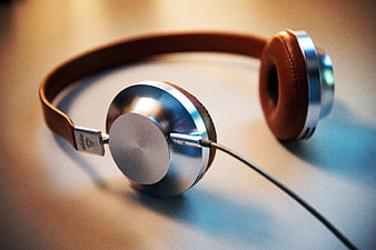 Silver and Brown Headphones on a Desk