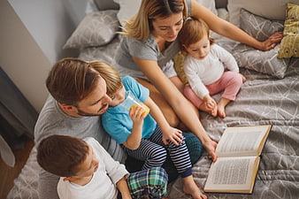 Family Reading Bedtime Story in Bedroom