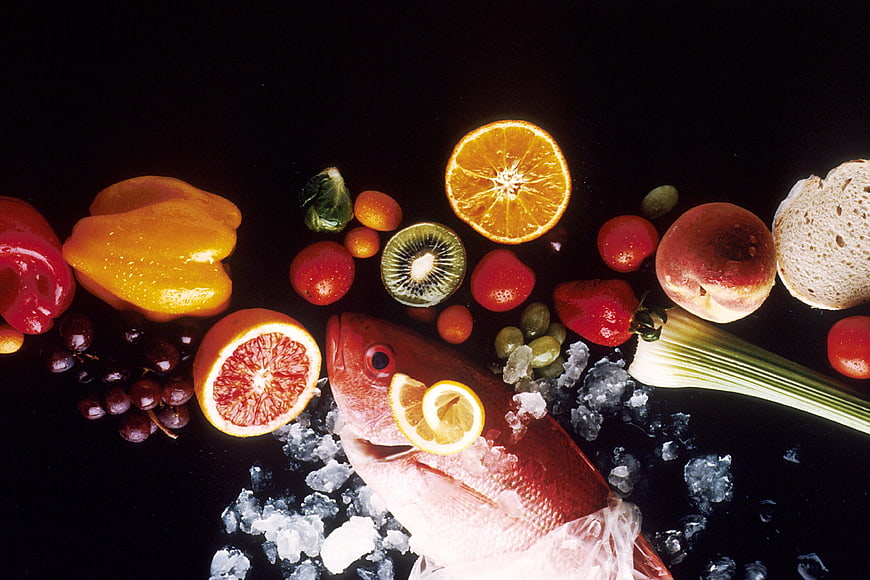 Fresh Red Snapper Fish on Ice with Assorted Fruits and Vegetables