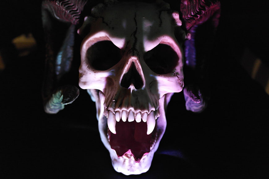 Dramatic Close-Up of a Horned Demon Skull in Dark Horror Setting