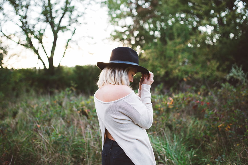 Blonde Woman in Hat Standing in Nature