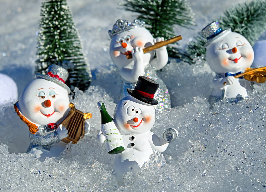 Cute Snowman Figurines Celebrating with Wine and Music in Snow