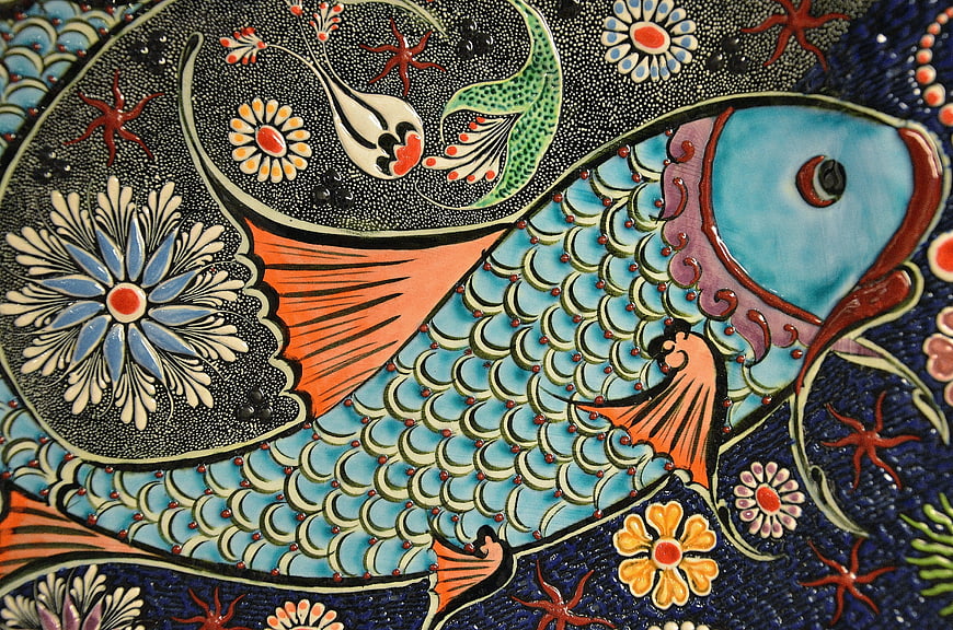 Colorful ceramic fish tile with floral mosaic pattern