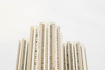 Low angle view of modern beige high-rise apartment buildings