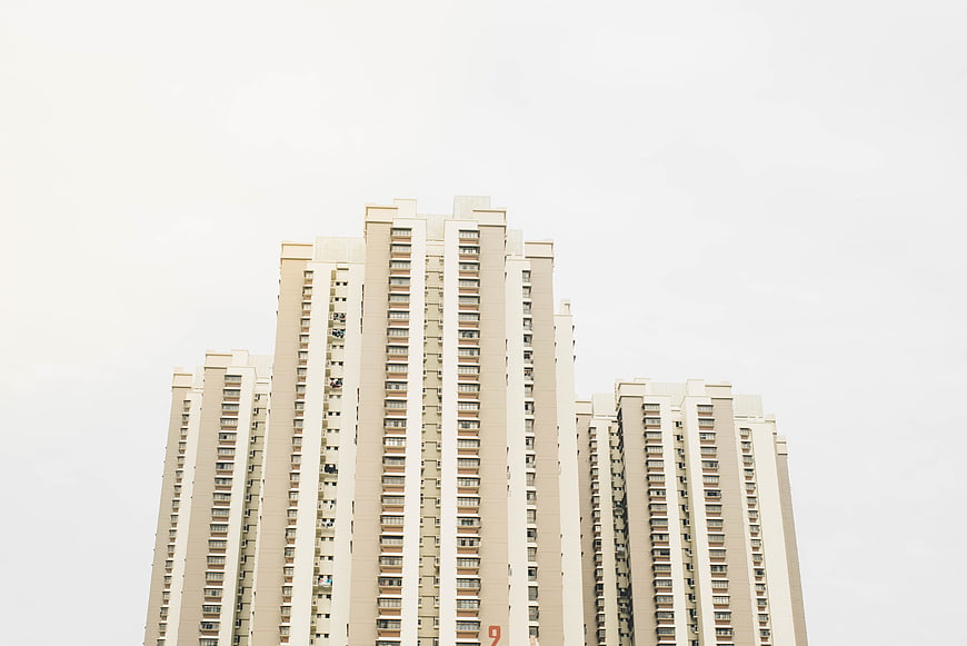 Low angle view of modern beige high-rise apartment buildings