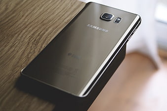 Close-up of Samsung Galaxy S6 Edge Plus on Wooden Table