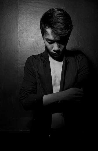 Moody Black and White Portrait of a Young Man Looking Down