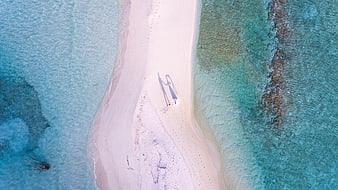 Aerial view of couple shadows on tropical sandbar