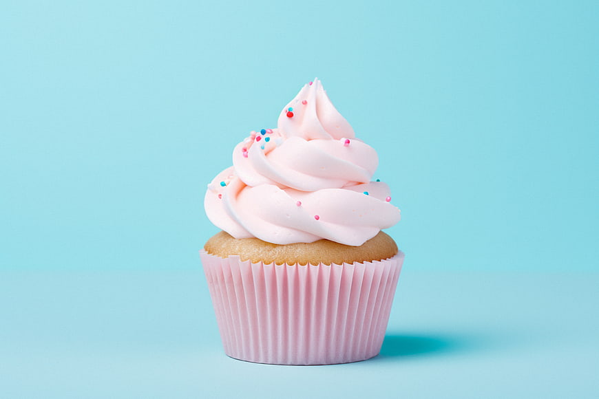 Pink Cupcake with Frosting on Blue Background