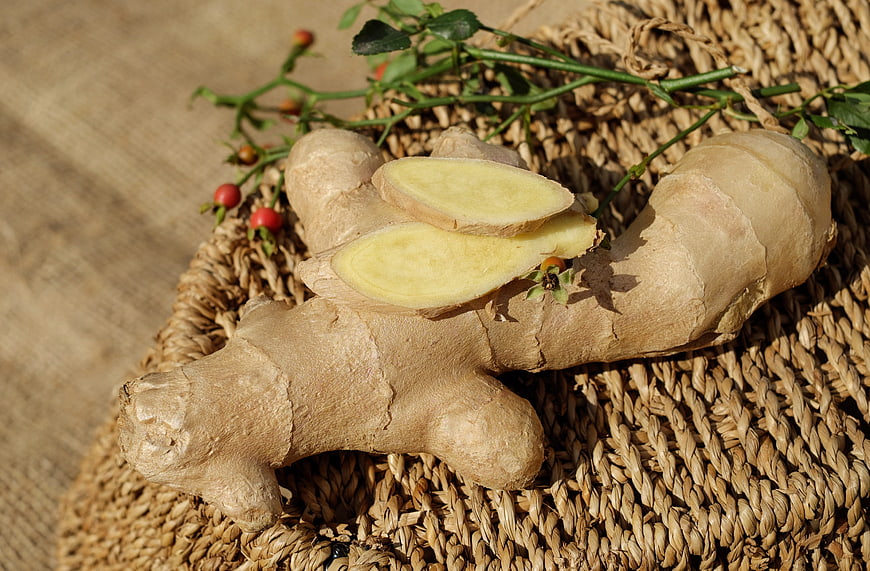 Fresh Ginger Root and Slices on Woven Straw Mat