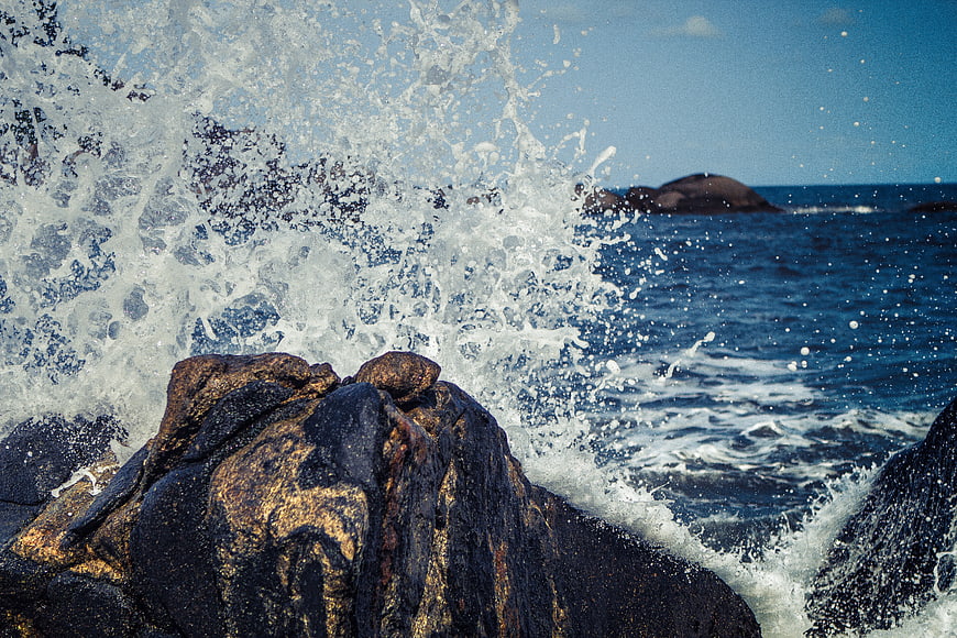 Powerful Ocean Wave Splashing Against Rocky Coastline