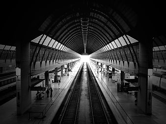 Black and white perspective of Santa Justa train station tracks
