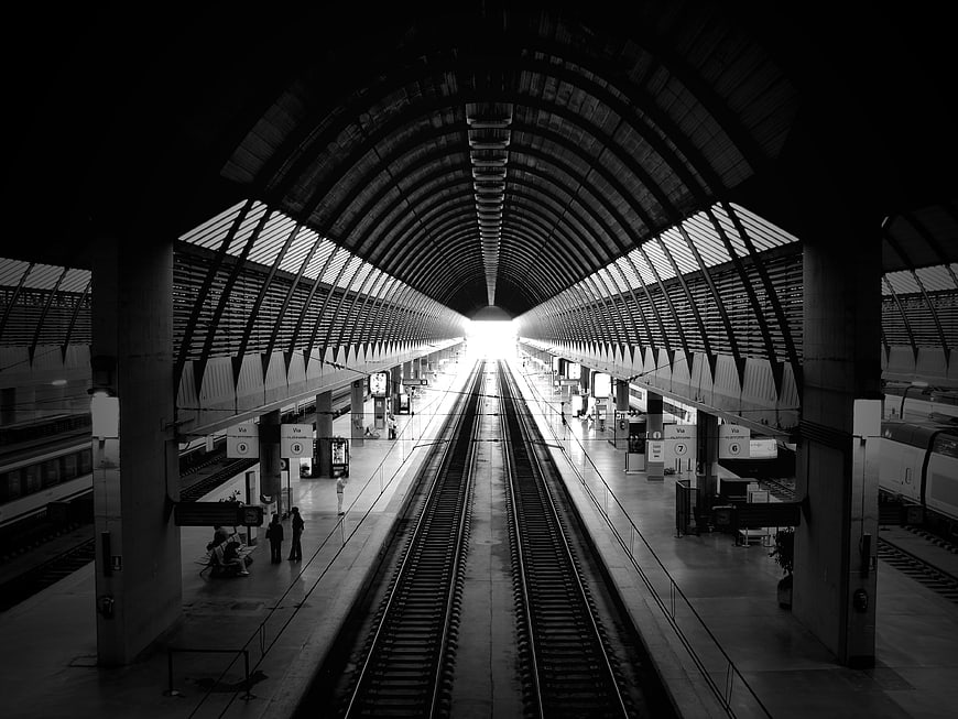 Black and white perspective of Santa Justa train station tracks